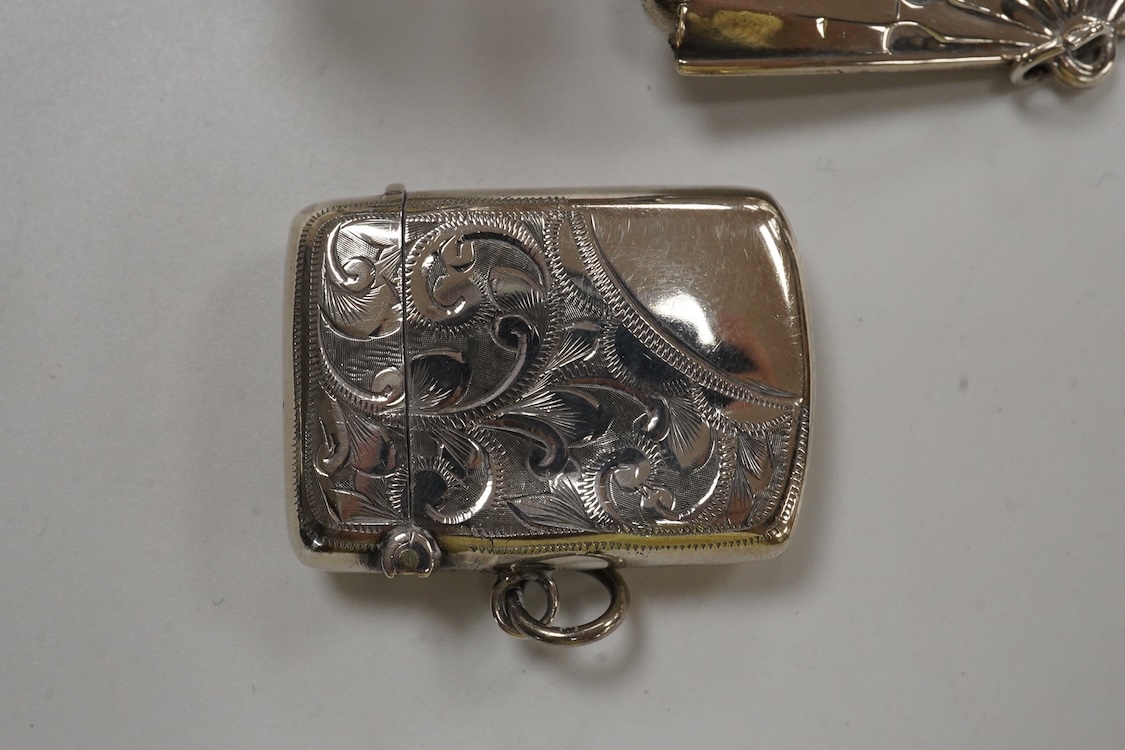 A George V silver mounted fan pin cushion, Henry Matthews, Birmingham, 1912, width 62mm, together with an Edwardian silver vesta case and a white metal pig vesta case.